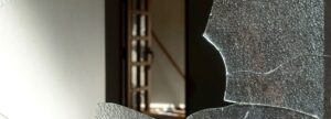 空き巣がガラスを割ったようなガラスが割れ部屋が見えている写真